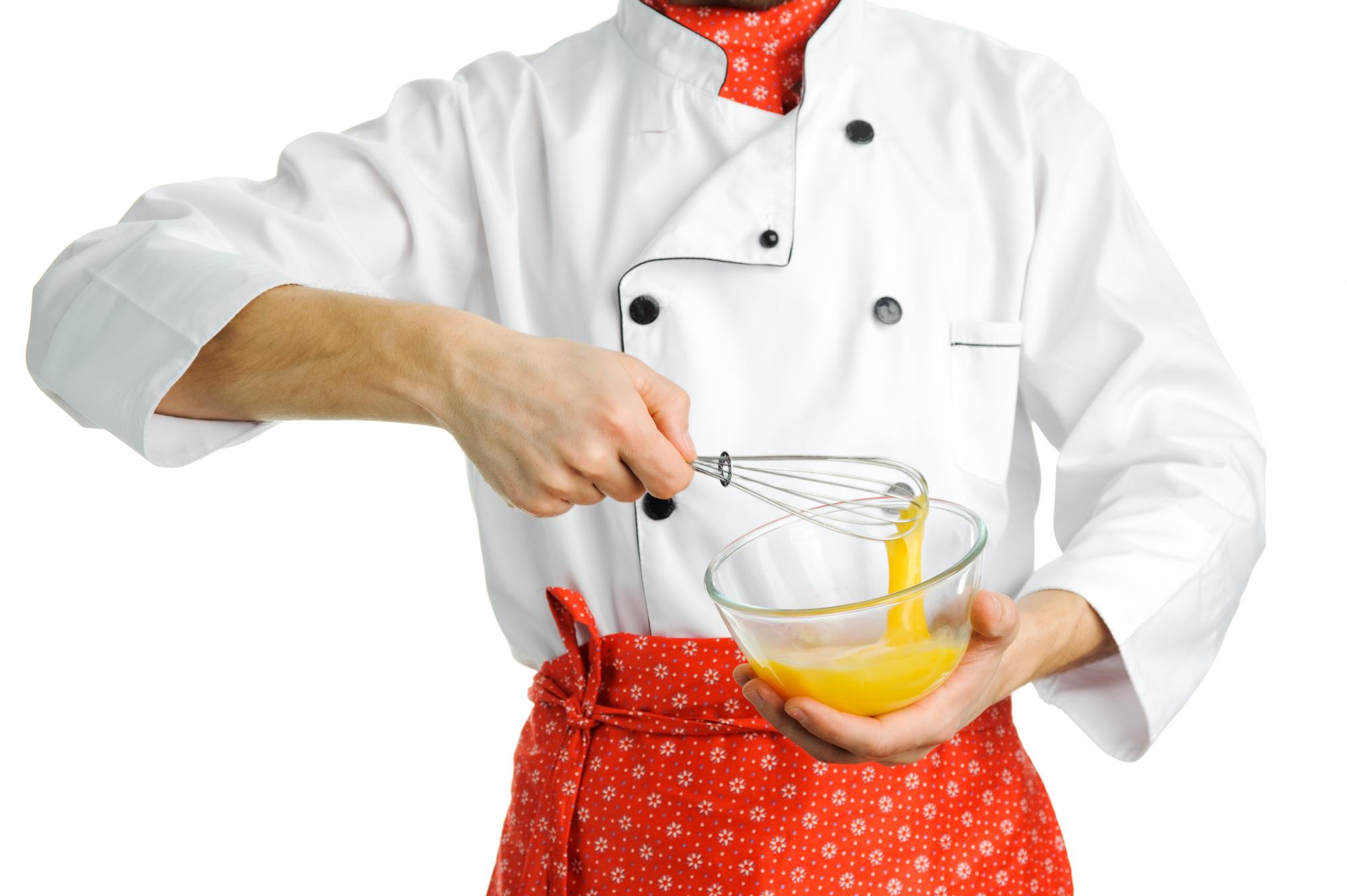 Chef hands finishing a plate with torch
